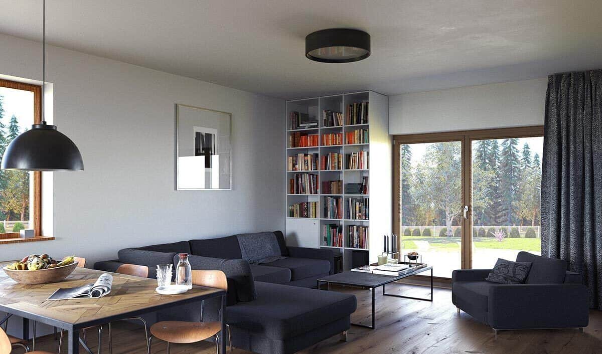 客厅里有一个嵌壁式书柜和灰色座椅，配上一张现代风格的咖啡桌。